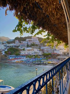 an ocean view with boats in the water and houses on the hill behind it at sunset