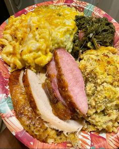 a plate with ham, macaroni and cheese, and other foods on it