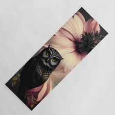 an owl is standing next to a flower on a piece of paper that looks like it has been painted