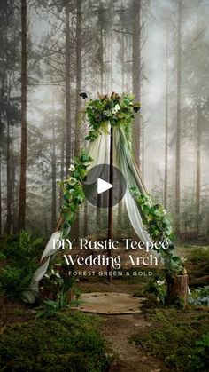 a wedding arch in the woods with greenery