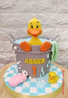 a birthday cake with a rubber ducky in a bathtub