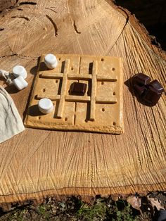 a waffle with marshmallows on it sitting on top of a piece of wood