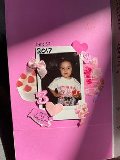 a child's scrapbook with pink and white decorations