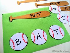 a bat and ball cut out on top of a green mat with the word bat in it