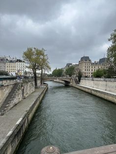 a river running through a city next to tall buildings