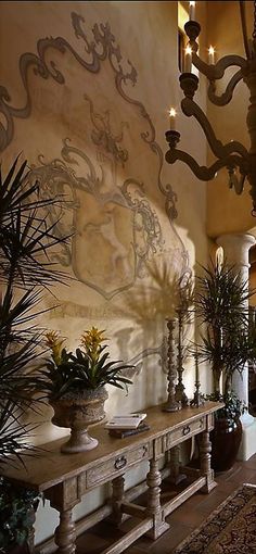 an ornately decorated hallway with potted plants and chandelier