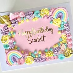 a happy birthday card with pastel flowers and rainbows