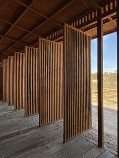 an empty room with wooden slats on the walls and wood flooring in front of it