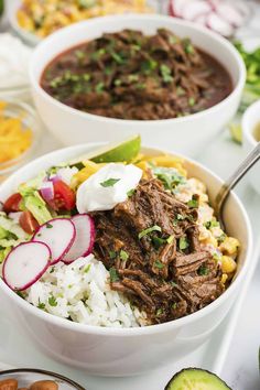 two bowls filled with beef, rice and veggies on top of a table