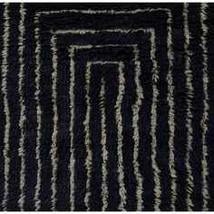 an area rug with black and white stripes on it, in the shape of rectangles