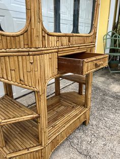 a bamboo shelf with two drawers on it