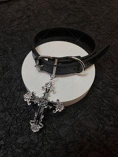 Embrace the edgy and punk vibe with our dark punk cross choker. This unique choker exudes a gothic and alternative aesthetic, perfect for expressing your individuality and subculture style. The choker features a striking cross pendant, adding a bold statement to your look.   Please note that this product includes one choker only. Gothic Choker For Concert, Black Gothic Choker For Alternative Fashion, Gothic Black Choker For Alternative Fashion, Gothic Choker For Halloween Concert, Black Gothic Choker, Emo Choker For Alternative Fashion, Silver Gothic Choker For Concert, Gothic Choker Jewelry For Streetwear, Gothic Choker For Streetwear