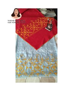 a red and blue scarf with gold designs on it