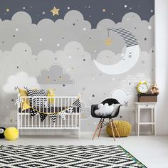 a baby's room with stars and clouds painted on the wall