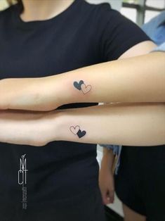 two people with matching tattoos on their arms