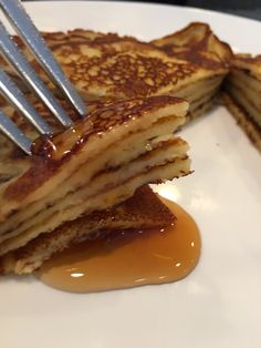 pancakes with syrup on a white plate