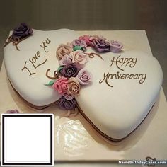 a heart shaped cake decorated with flowers and the words i love you, happy anniversary