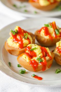 eggs with ketchup and green onions on a white plate