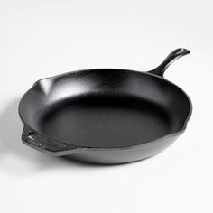 a black frying pan on a white background with the handle extended to the side