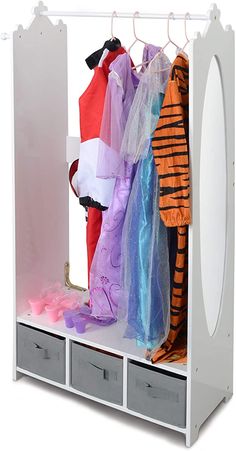 an open closet with clothes hanging on the rack and two drawers below it, along with other storage bins