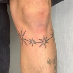 a man's arm with three stars on it