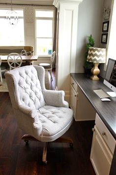 a chair sitting on top of a hard wood floor next to a desk with a computer