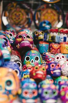 there are many colorful skulls on display for sale