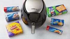 an air fryer surrounded by snacks and candy