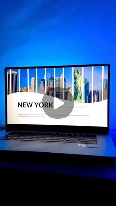 an open laptop computer sitting on top of a desk in front of a blue background