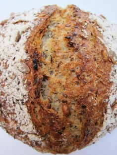 a close up of a loaf of bread on a white surface