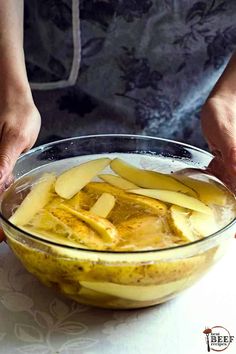 someone is peeling bananas in a glass bowl