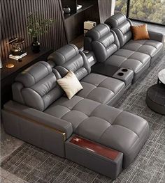 a modern living room with grey leather couches