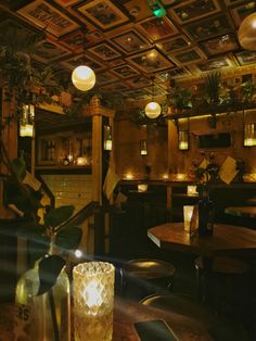 a dimly lit restaurant with tables and chairs