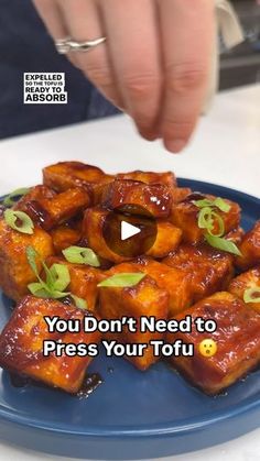 a blue plate topped with tofu and text that reads, you don't need to press your tofu button