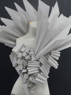 a sculpture made out of white paper sitting on top of a table