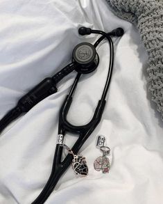 a stethoscope laying on top of a white blanket