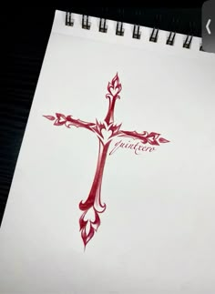 a drawing of a cross with the word faith written in red ink on white paper