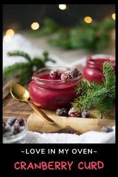 cranberry curd in a jar on a cutting board with christmas greenery