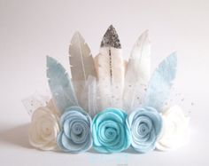 a white and blue flower crown with feathers