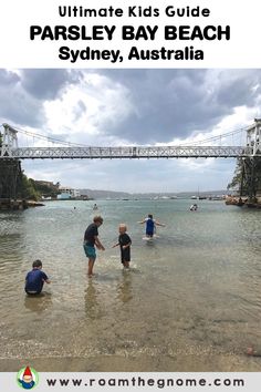 kids playing in the water at parsley bay beach sydney australia with text overlay