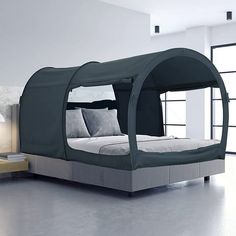 a bed with a canopy over it in a room