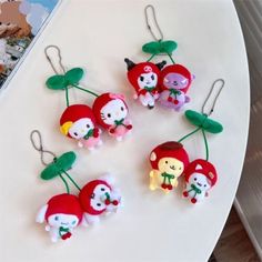 four different keychains with cartoon characters on them sitting on a white table in front of a magazine