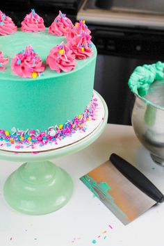 a cake with sprinkles on it sitting on a table