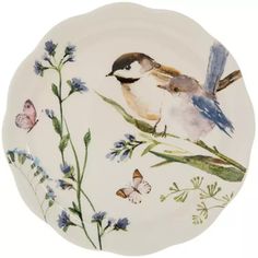 a white plate with two birds and flowers on it