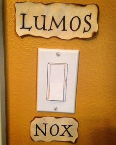 a light switch with two signs on it that say lumos and nox in spanish