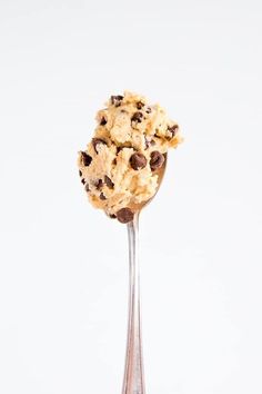 a spoon filled with cookies and chocolate chips