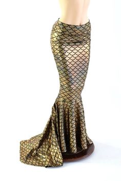 a mannequin is dressed in gold and black mermaid tail skirt with sequins