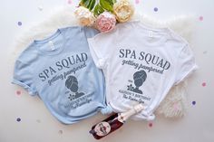 two spa t - shirts sitting next to each other on a white furnishing