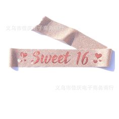 a pink ribbon with the words sweet 16 on it