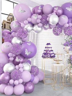 a purple and silver baby shower with balloons